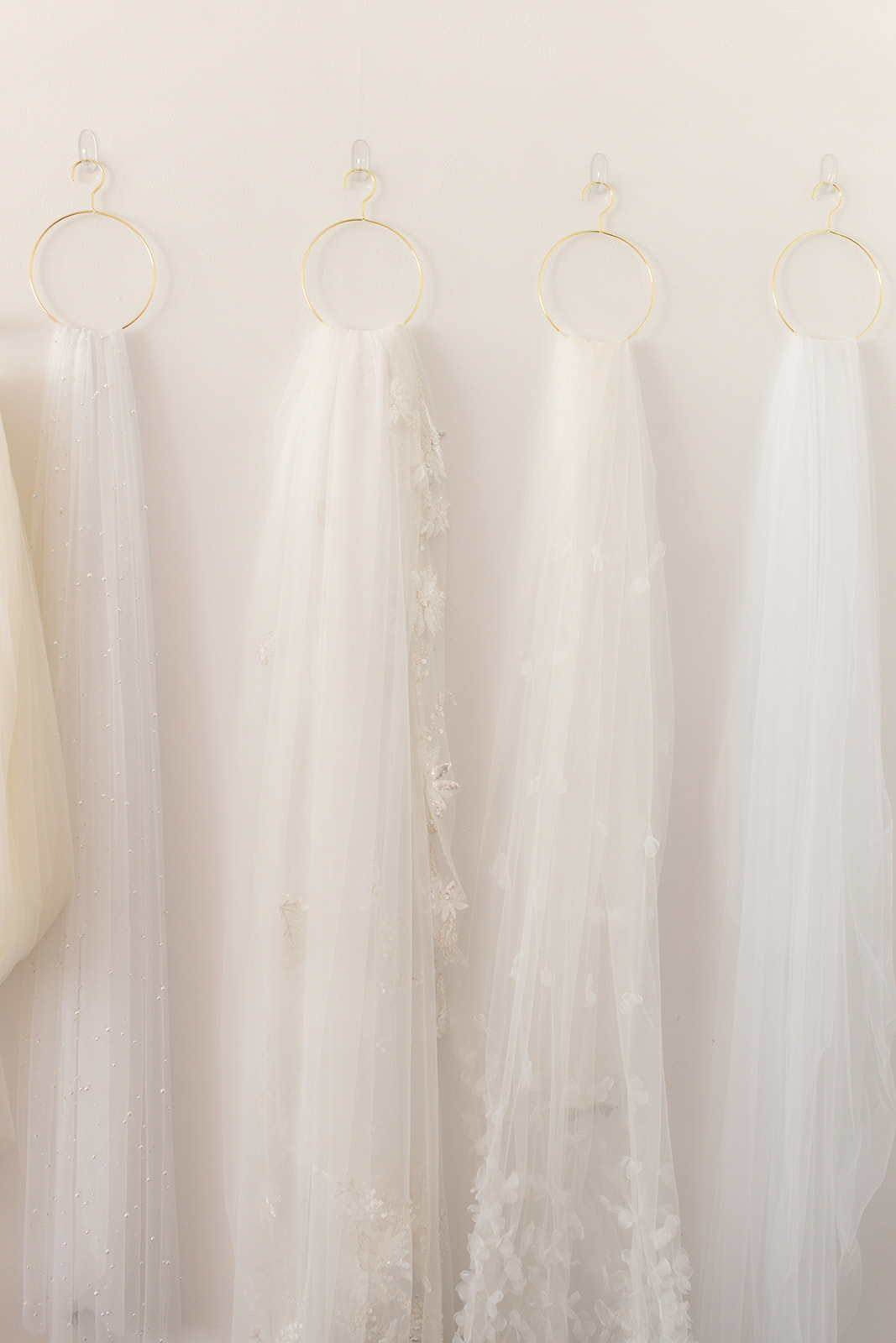 white bride dresses hanging on the wall